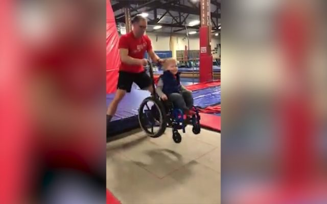 A Boy in a Wheelchair Bouncing on a Trampoline